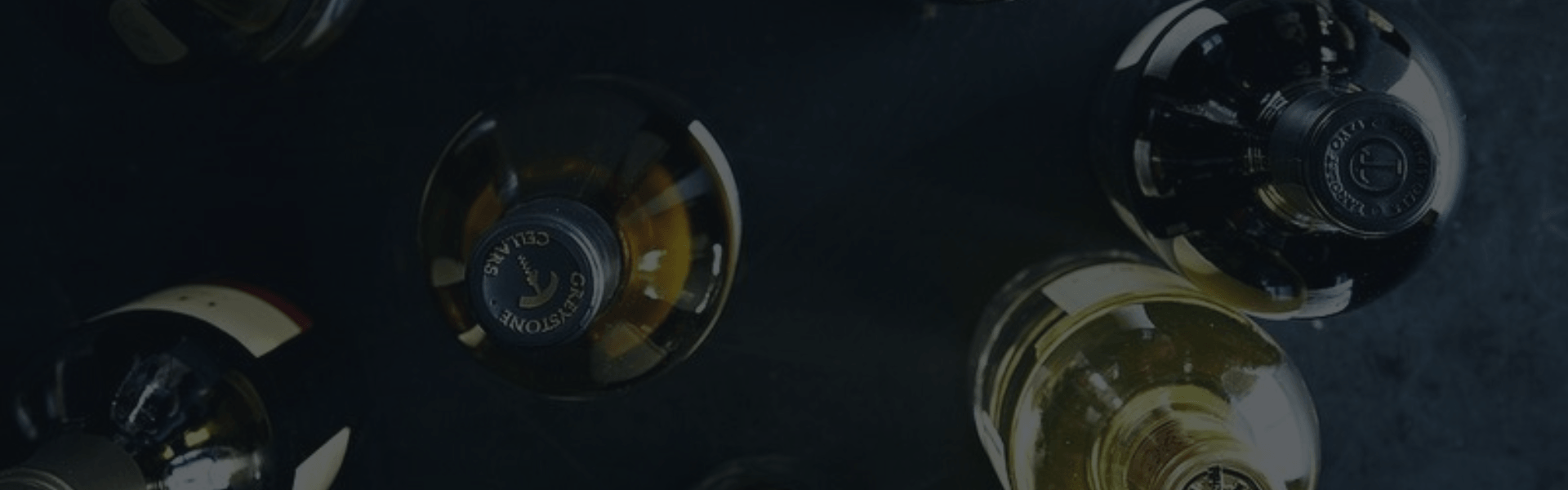 Close-up of wine bottle caps on a dark background